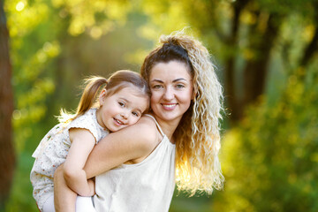 Fototapeta premium Mother with her cute little daughter in nature
