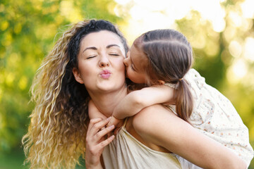 Fototapeta premium Mother with her cute little daughter in nature, closeup