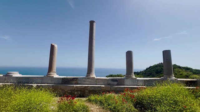 Ancient Roman stone columns ruins of Antiochia ad Cragum archaeological site in Turkey against blue sky