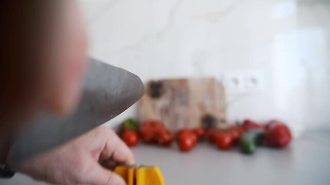 Hands Hone Large Kitchen Knife With Sharpener In Kitchen, Object POV camera angle shot