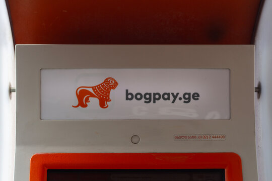 Tbilisi, Georgia - May 19, 2026: Horizontal street photo close up. Orange Bank of Georgia, BOG logo on ATM. GEL bill, lari. Concept of business, plastic card, budget, cash money, debt, pay tax, loan
