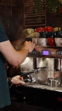 A professional bartender prepares fresh coffee in a stylish caf&eacute; atmosphere. Close-up details, steam, coffee aroma, and cinematic lighting create a cozy premium hospitality scene perfect for caf&eacute;s, re