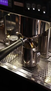 A professional bartender prepares fresh coffee in a stylish caf&eacute; atmosphere. Close-up details, steam, coffee aroma, and cinematic lighting create a cozy premium hospitality scene perfect for caf&eacute;s, re