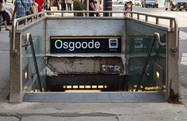 Fototapeta premium Subway entrance with stairs descending into underground Osgoode Station in downtown Toronto, showing urban metro transit infrastructure and commuter access point in May 2026