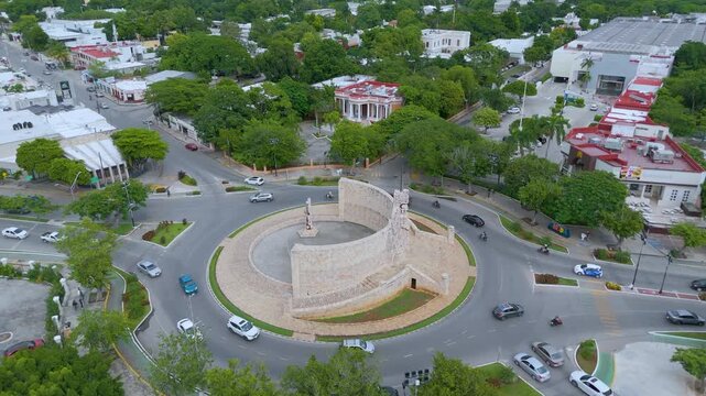 A high-angle aerial landscape shot captures the magnificent Monumento a la Patria, located in a prominent traffic roundabout along the iconic Paseo de Montejo avenue in M&eacute;rida, Mexico.
