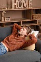 Obraz premium Young woman relaxing on sofa at home