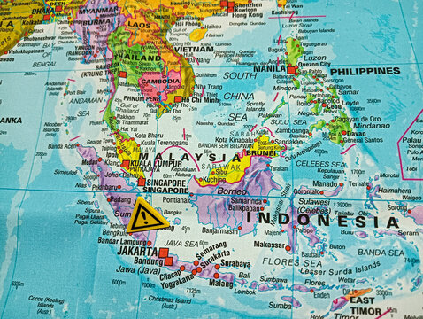 Close-up map of Southeast Asia featuring Malaysia, Indonesia, and neighboring countries with a warning symbol, representing travel alerts, geopolitics, navigation, and regional awareness.