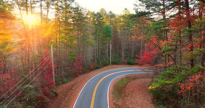Golden autumn landscape in Appalachian mountains of North Carolina. Forest road winds through hills with vibrant fall foliage