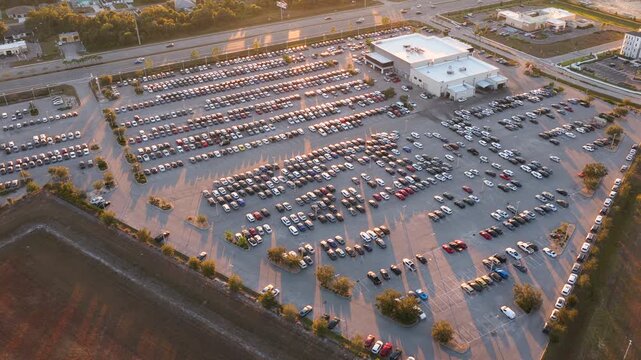 Car showroom exterior with brand new vehicles in stock, clean parking lot and modern infrastructure, representing automotive business, leasing services and dealership marketing.