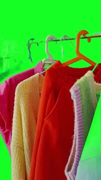 clothes hanger with colorful clothes  in green scren background