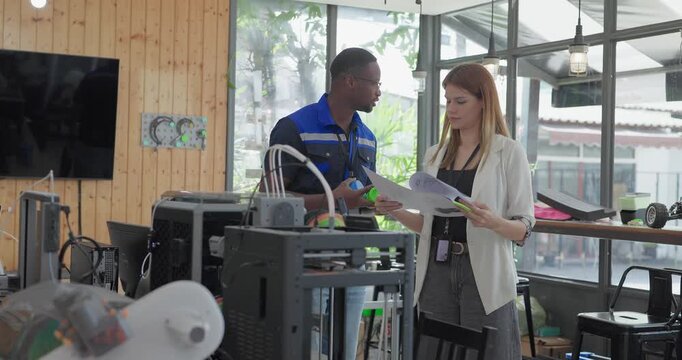 Engineer and Product Designer Reviewing Technical Blueprints