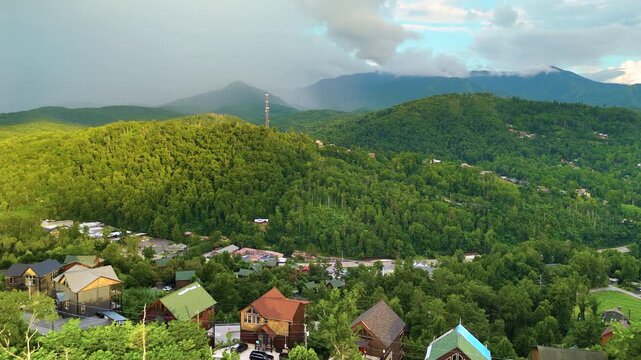 Aerial panorama of mountain residences in Tennessee surrounded by dense forest, winding roads and scenic Appalachian scenery