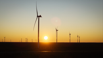 Fototapeta premium Wind turbines generating renewable energy during sunset near Puerto Madryn in Patagonia Argentina.