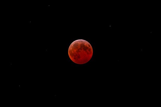 Total Lunar Eclipse with Bright Red Blood Moon in Dark Night Sky