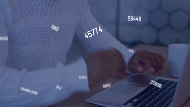 Mature analyst scanning data, tapping trackpad, typing on laptop with numeric overlays floating