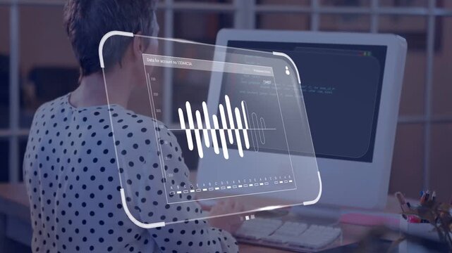 Woman typing on keyboard at desk activating hologram waveform panel over screen for audio review