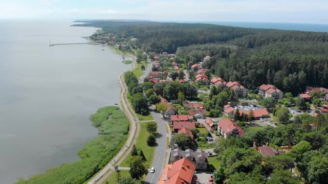 Drone shot capturing the picturesque town of Juodkrantė, a popular summer resort located on the Curonian Spit, a UNESCO World Heritage site in Lithuania.