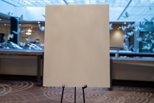 Blank presentation board on stand at conference venue.