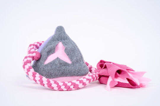 Gray and pink felt triangle snuffle toy with braided pink rope on white background, handmade pet enrichment product concept.