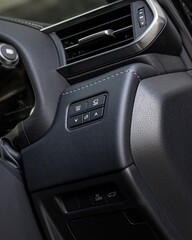 Obraz premium Modern car interior dashboard and steering wheel close up.