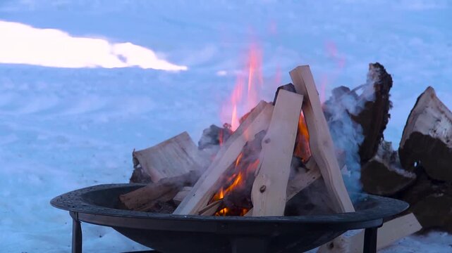 wood burning on a frozen lake in alaska
