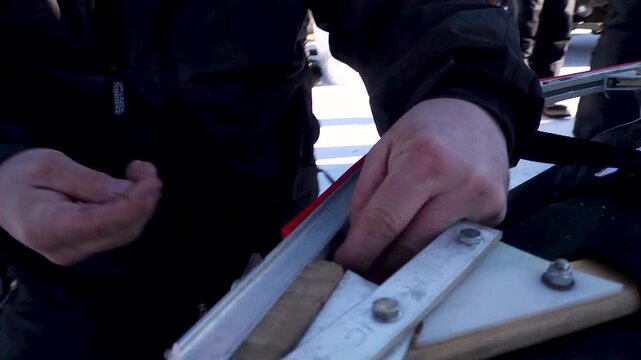 Close up of musher working on his dog sled