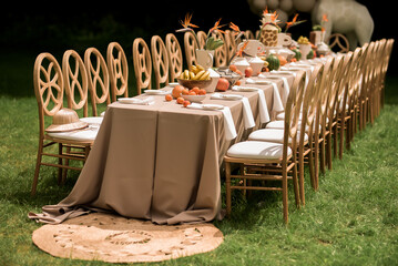 Cinematic bohemian banquet table with woven textures tropical accents and artisan styling curated for upscale outdoor celebrations © Nele