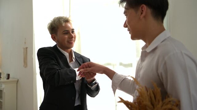 A gay couple got engaged by putting a ring on their partner's finger while they were enjoying music and having fun together at home