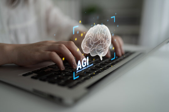 Hands Typing on Laptop Keyboard with Augmented Reality Display of Brain Icon Representing Artificial General Intelligence Concept Haptic.