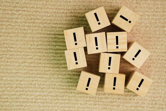 Wooden cube with icons or symbols of caution or precautions. importance of caution and awareness in various situations, reminding individuals to be mindful and prepared for potential risk