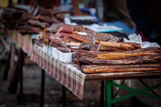 Pecenica, slanina, and dried meat called suvo meso and other Serbian cured meat displayed on a market stand, showing traditional pork products and Balkan food culture in Serbia.
