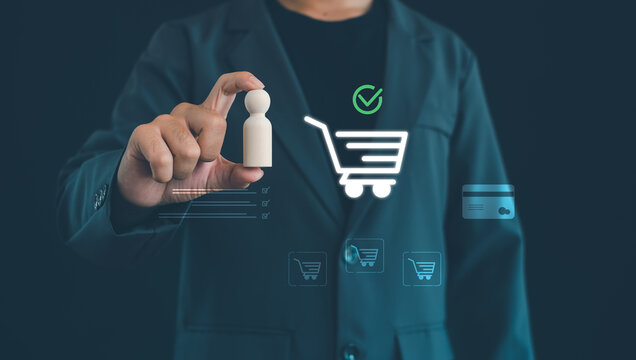 Business professional analyzing customer shopping behavior with digital cart, online payment and consumer targeting interface, representing ecommerce marketing, buyer persona and retail strategy.