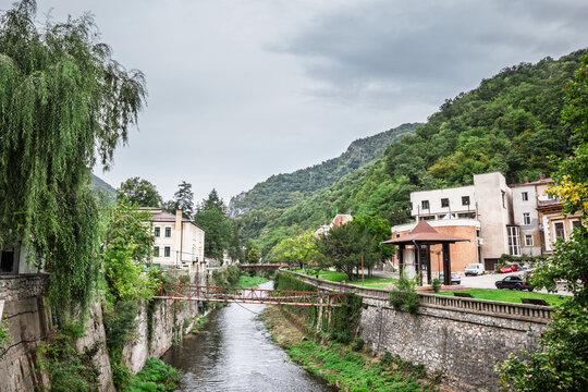 Panorama of the river Cerna in Baile Herculane, Romania, with individual houses, in the middle of the mountains in the romanian countryside.