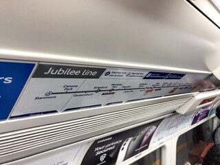 Fototapeta premium London, United Kingdom, 14 July 2023, Jubilee Line route map inside London Underground train carriage. Station names and transport zones visible above passenger seats.