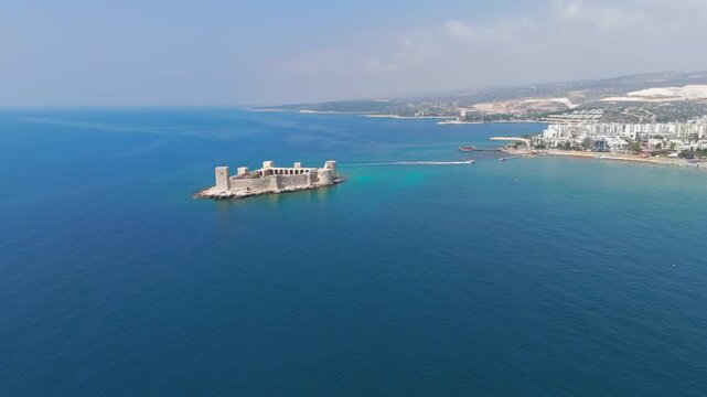 Kizkalesi, Mersin, Turkey. Aerial panoramic view of Maiden Castle stone fortress with medieval towers and ramparts on small Mediterranean island under clear summer sky.. Aerial View