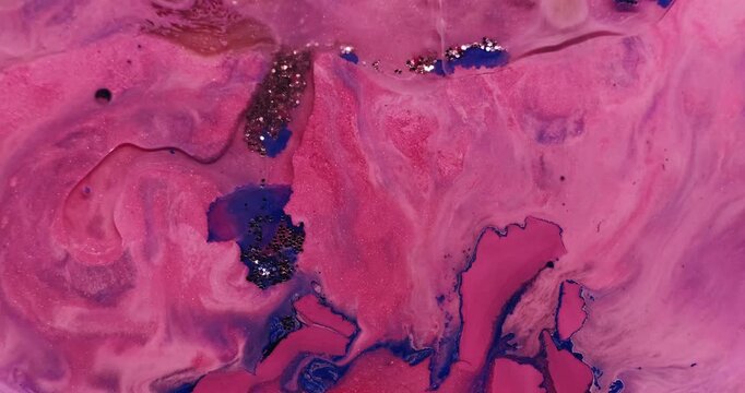 Blend paint. Glitter texture. Defocused pink purple blue colorful sequins splash liquid spreading on abstract acrylic art background.