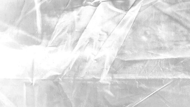 White Wrinkled Plastic Film Texture.Animated abstract background featuring crumpled transparent plastic wrap overlay effect.