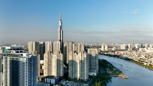 Ho Chi Minh City, Vietnam &ndash; 4K aerial sunrise drone view of downtown skyline with modern skyscrapers, dense urban housing, busy streets and morning traffic along the Saigon River in Southeast Asia