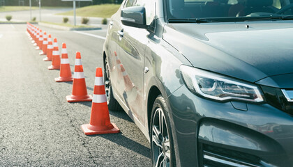 Fototapeta premium Car Driving Through Traffic Cones On Road During Safety Control Setup