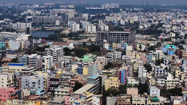 Kattamysamma Lake with under construction buildings, apartments and Residential buildings at suraram, jeedimetla, hyderabad, telangana, india. day time, push back shot, drone shot, 4k.