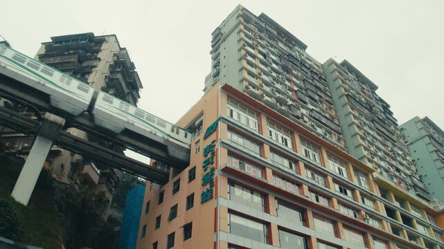 Chongqing Liziba Monorail Train Passing Through Residential Building Low Angle Daytime(1)