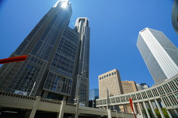 Tokyo Metropolitan Government Building in Shinjuku reaching high into a clear blue sky, emphasizing modern architecture and urban development in the bustling Japanese capital © Rahman