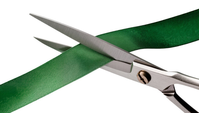 Sharp metal scissors cutting a green satin ribbon, isolated on transparent background