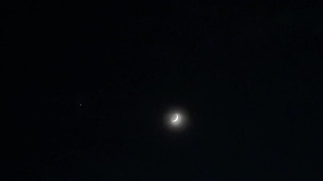 Moon visible in nighttime sky with atmospheric celestial scene and natural nocturnal sky backdrop