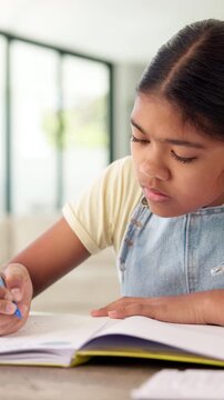 Education, child and writing on paper in home for math homework, calculation solution or study. Student, kid or numeracy worksheet in house for problem solving, division answer or learning assessment