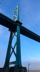 Fototapeta premium Lions Gate Bridge tower low angle view from Vancouver Seawall