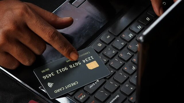 Credit Cards Theft. Hacker with Credit Cards on His Laptop Using Them For Unauthorized Shopping. Unauthorized Payments. Stolen Credit Cards Concept.