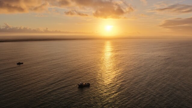 Beachport, South Australia at sunrise: 4K aerial drone view of coastal town, jetty, calm ocean, Southern Ocean Beach and golden morning light.