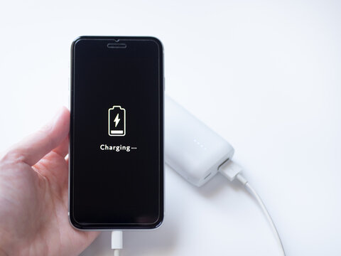電池残量がわずかのスマホにモバイルバッテリーを接続して充電する様子（画面デザインはオリジナル制作）