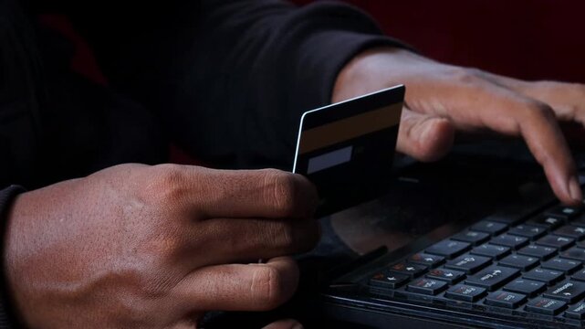 Credit Cards Theft. Hacker with Credit Cards on His Laptop Using Them For Unauthorized Shopping. Unauthorized Payments. Stolen Credit Cards Concept.